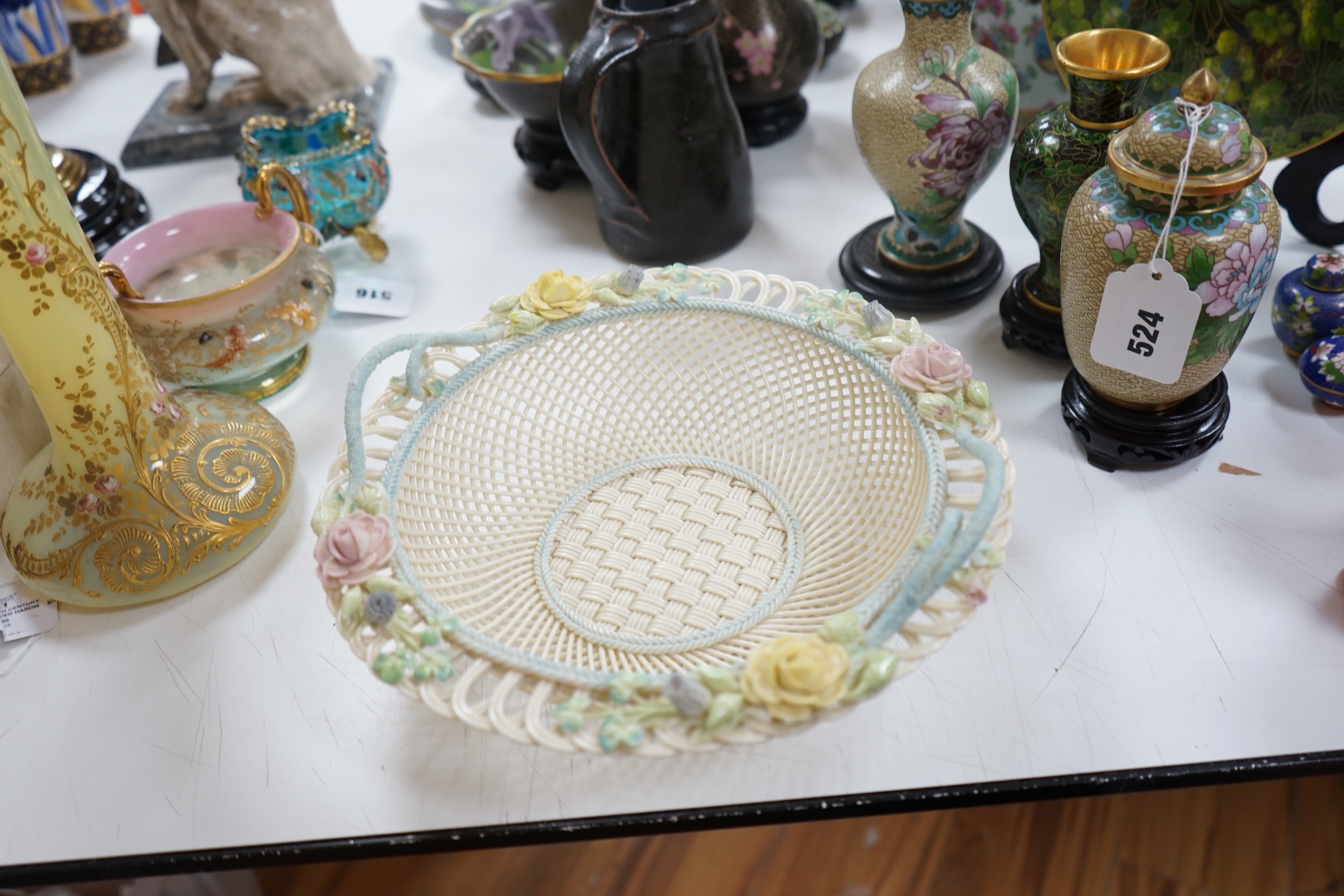 A boxed Belleek coloured basket, 28cm diameter. Condition - fair to good, some damage and wear to the box.